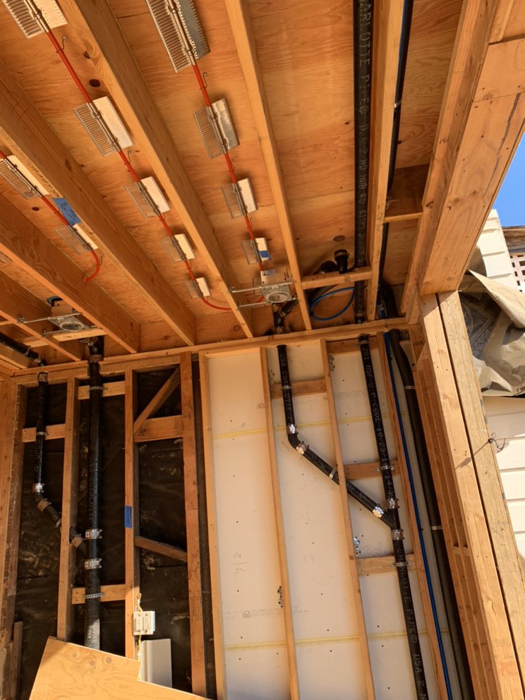 PEX home-run manifold and DWV vent stack rough-in plumbing during new home construction in Nashville, TN